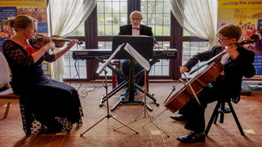 undefinedHarry Scott-Burt, and parents Nick and Cathy, performing to raise funds for the Loan Scheme